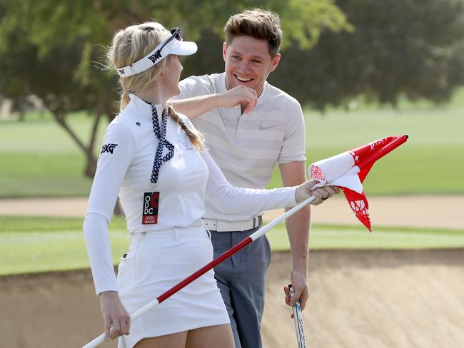 Niall Horan the music artist enjoys a lighthearted moment with Paige Spiranac during the pro-am for the Omega Dubai Desert Classic.