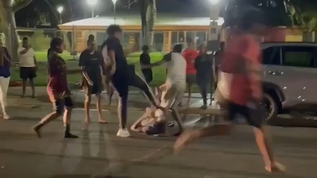*A young male kicks another who is on the ground during a street brawl in Alice Springs.