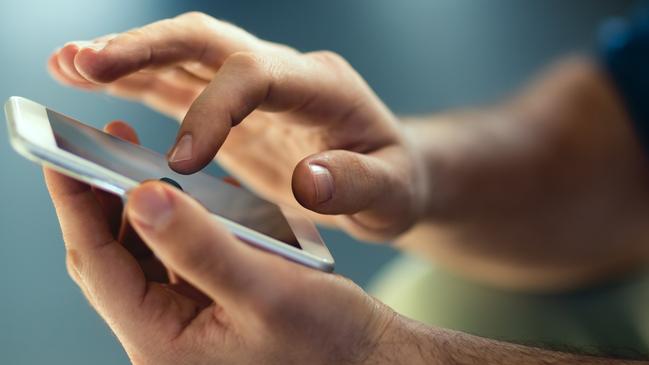 Generic Male hands typing on smartphone. Picture: Istock