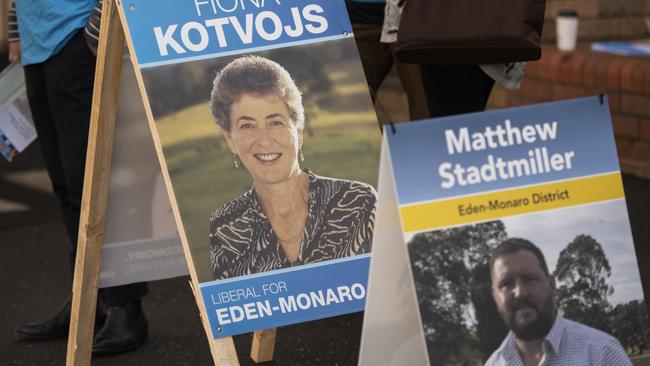 Election signages for Liberal candidate Fiona Kotvojs and Shooters, Fishers and Farmers candidate Matthew Stadtmiller are displayed outside a voting centre in Queanbeyan. Picture: Getty Images