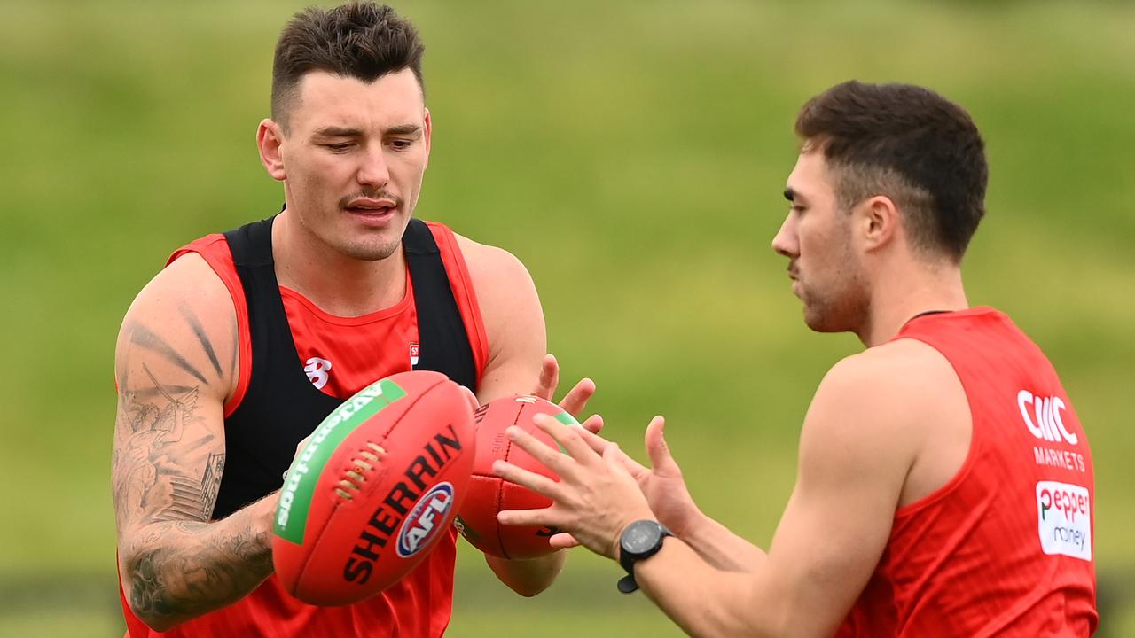 Josh Battle and Jade Gresham during a handball drill. Picture: Quinn Rooney/Getty Images