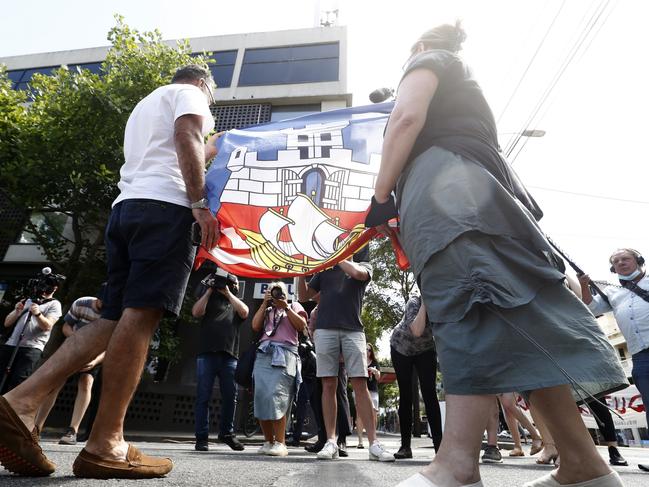 Serbian tennis fans hold hold the flag of Belgrade outside the Park Hotel in Carlton. Picture: Getty Images