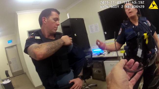 Constable Zachary Rolfe examines a stab wound to his shoulder while inside the Yuendumu police station on the night of November 9, 2019. Picture: NT Courts