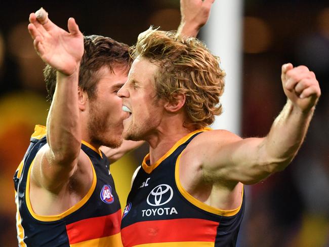 Paul Seedsman and Rory Sloane of the Crows celebrate a goal against Richmond.