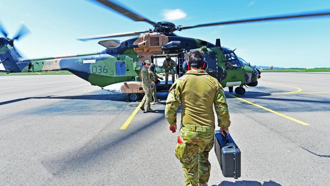 Members from 5th Aviation Regiment get on board a MRH-90 Taipan\. Picture: Zak Simmonds