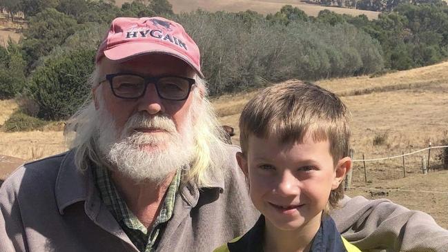 Flowerdale residents Rob and his grandson Toby are safe while the grassfire burns near their home. Picture: Supplied