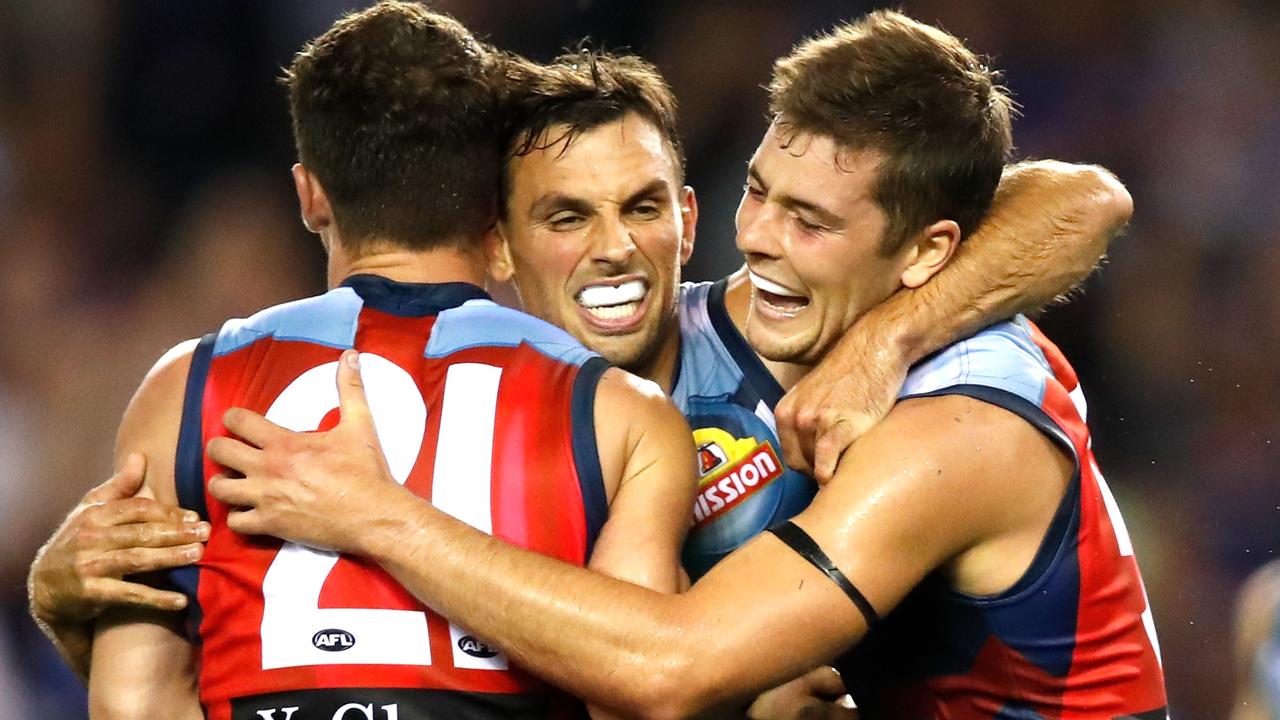 Tom Liberatore, Sam Lloyd and Josh Dunkley celebrate the Bulldogs’ win.