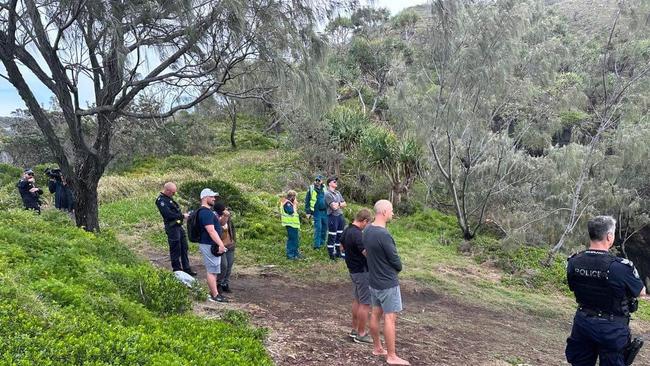 Onlookers watch as a woman is prepared to be winched to safety. Photo: Craig Warhurst