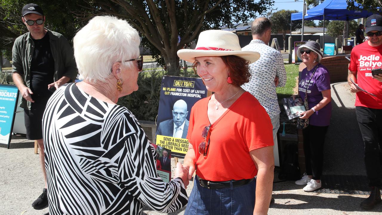 Labor candidate for the Dunkley by election, Jodie Belyea (right) greets a voter at the early voting centre at Carrum Downs Community centre. Picture: NCA NewsWire / David Crosling