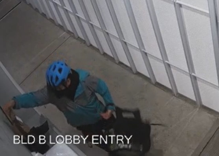 A delivery rider was captured taking a package from the apartment’s lobby. Picture: supplied