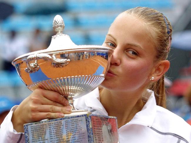 Although her career kept hitting new heights having made five finals, including winning two and finishing world No. 8 — Dokic pictured here with the Italian Open title after defeating Amelie Mauresmo — off court it was a different story.