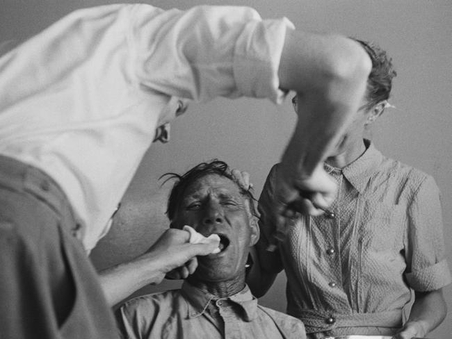 An immigrant is seen receiving dental treatment, taken in 1954. Picture: Thurston Hopkins/Getty Images