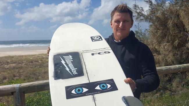 Kingscliff big wave surfer Justin Holland with the Shark Eyes product on his surfboard.