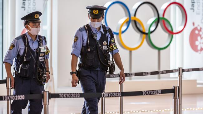 Police officers patrol around the arrival gate at Haneda airport in Tokyo. Picture: Getty Images