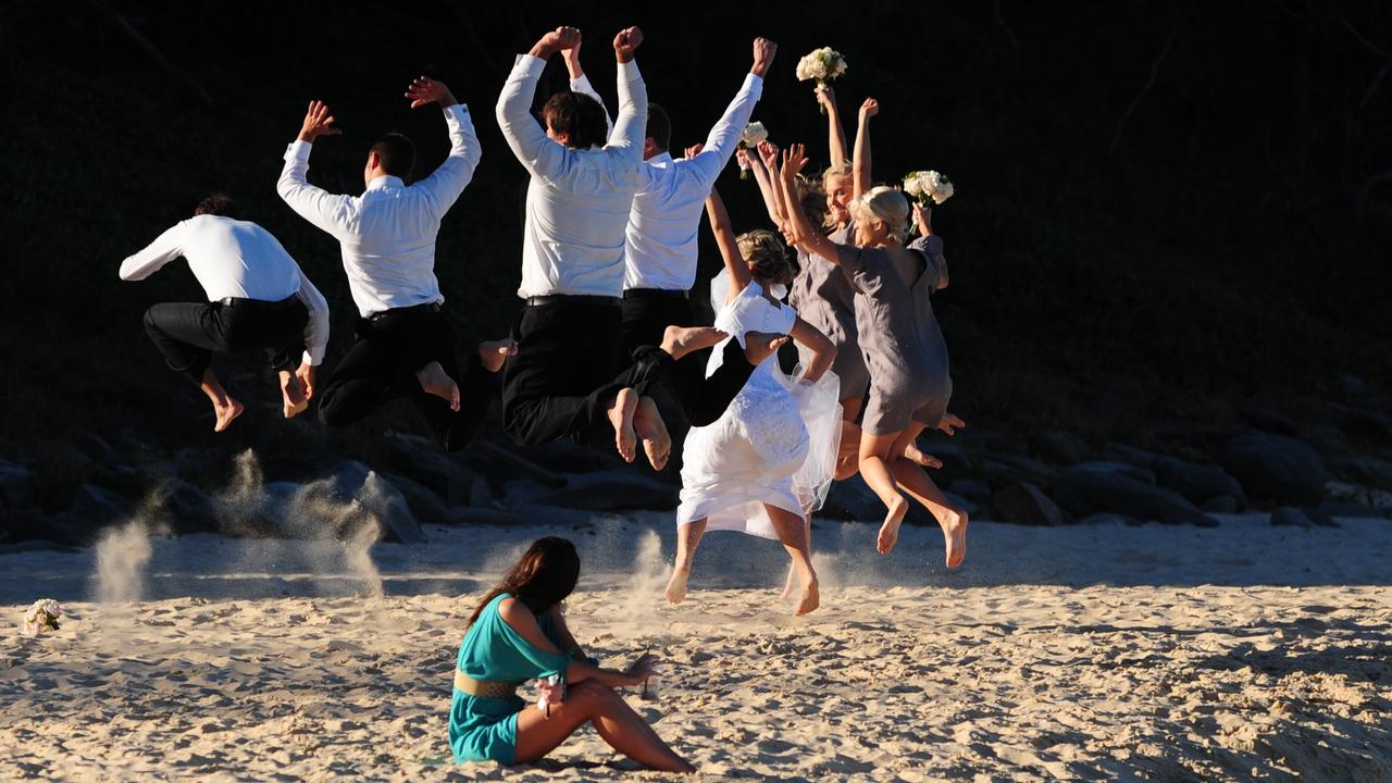 A wedding party gets its photo taken at the Pocket at Point Cartwright and steals the solitude a woman was enjoying. Picture: Brett Wortman