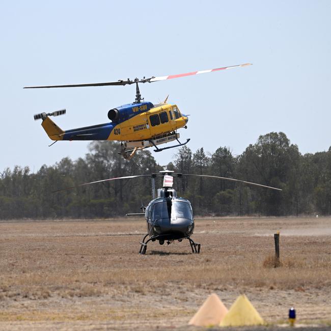 A fire bombing helicopter lands in Tara, Queensland, about 300 kilometres west of Brisbane. Fire fighters have been battling multiple bushfire in Queensland and NSW. Picture: NCA NewsWire / Dan Peled