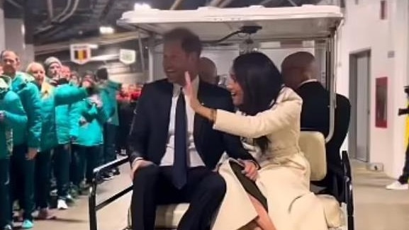 Prince Harry and Meghan Markle on the controversial golf buggy.