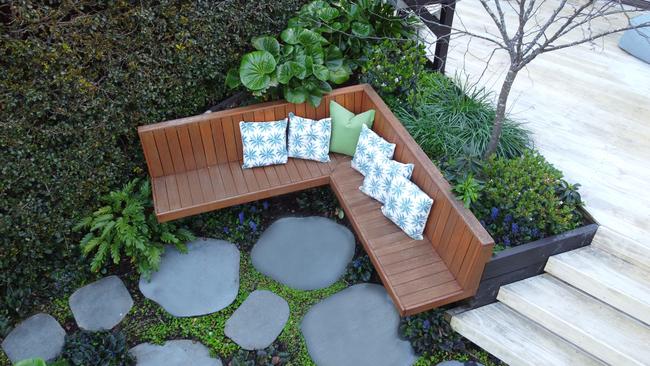 Floating timber steps lead to a casual space with oversized bluestone steppers. Picture: Katrine Mardini