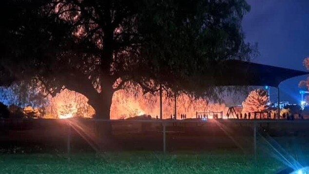 The fire burning next to a playground Ladbury Av, on Monday night. Source: Facebook