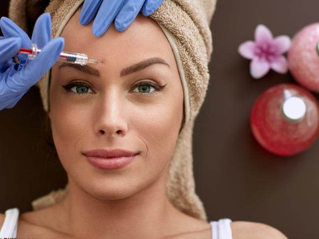 REAL DOLLS FEATURE stock image.Picture: iStock Beauty woman giving injections. as correction of wrinkles, cosmetic treatments