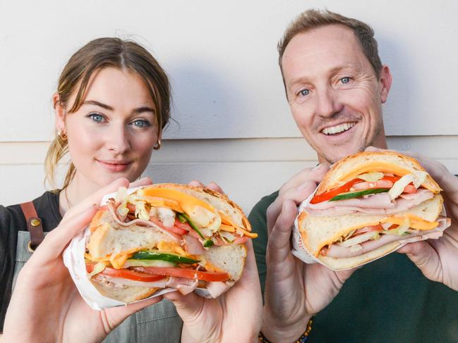 Good Neighbour Deli owner Brett Hicks-Maitland and double cut diva Niamh Montague with a ham, cheese and salad double cut roll at Lot 14, March 22, 2023. Picture Brenton Edwards