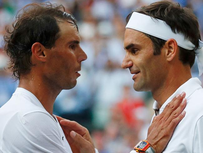 (FILES) In this file photo taken on July 12, 2019 Switzerland's Roger Federer (R) shakes hands and embraces Spain's Rafael Nadal (L) after Federer won their men's singles semi-final match on day 11 of the 2019 Wimbledon Championships at The All England Lawn Tennis Club in Wimbledon, southwest London. - Swiss tennis legend Roger Federer is to retire after next week's Laver Cup, he said on September 15, 2022. (Photo by Adrian DENNIS / POOL / AFP) / RESTRICTED TO EDITORIAL USE