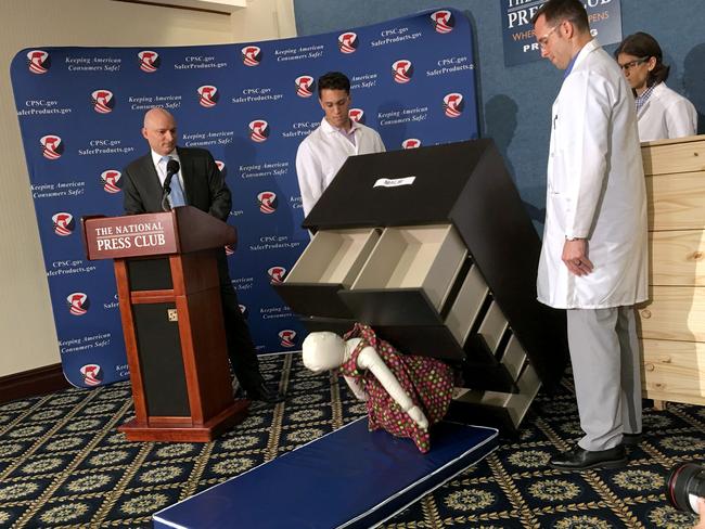 Elliot Kaye (L), chair of the Consumer Product Safety Commission (CPSC) and CPSC employees watch as a 13 kilo dummy (C) falls over and under IKEA’s Malm model chest of drawers, during a live demonstration. Picture: AFP