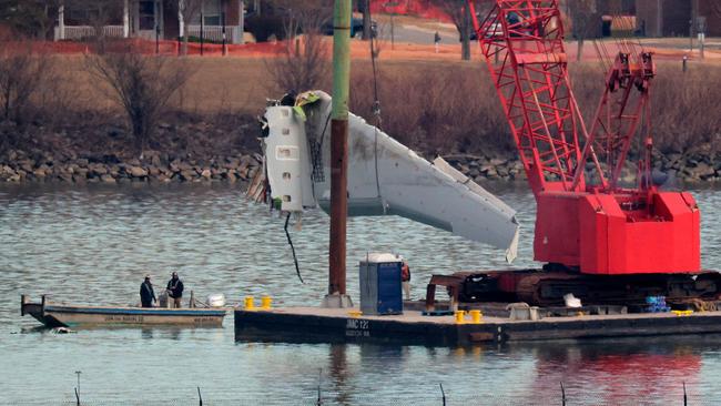 ARLINGTON, VIRGINIA - FEBRUARY 03: A wing of American Airlines flight 5342 is lifted from the Potomac River during recovery efforts on February 03, 2025 in Arlington, Virginia. An American Airlines flight from Wichita, Kansas collided midair with a military Black Hawk helicopter while on approach to Ronald Reagan Washington National Airport on January 29, 2025 outside of Washington, DC. According to reports, there were no survivors among the 67 people onboard both aircraft.   Chip Somodevilla/Getty Images/AFP (Photo by CHIP SOMODEVILLA / GETTY IMAGES NORTH AMERICA / Getty Images via AFP)