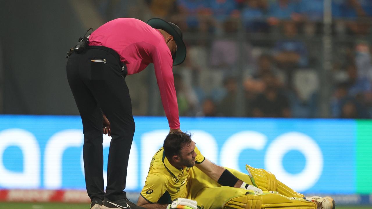 Glenn Maxwell receives medical attention as Match Umpire Alex Wharf looks on. Picture: Getty