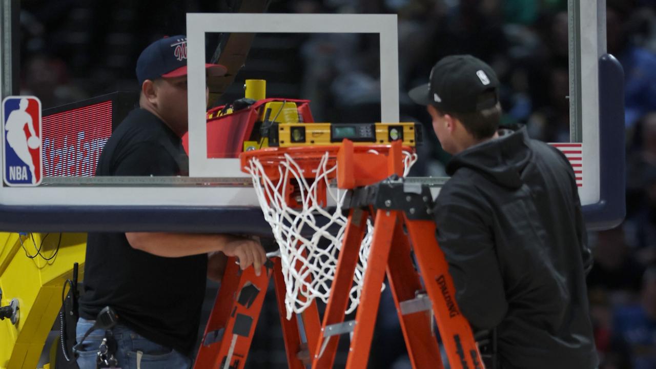 DENVER, COLORADO – JANUARY 01: Play is halted between the Denver Nuggets and the Boston Celtics as workers repair the rim during the fourth quarter at Ball Arena on January 01, 2023 in Denver, Colorado. NOTE TO USER: User expressly acknowledges and agrees that, by downloading and/or using this photograph, User is consenting to the terms and conditions of the Getty Images License Agreement. (Photo by Matthew Stockman/Getty Images)