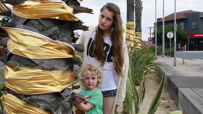 Tayla, 12, and Amelia, 4, are less than impressed with Bayside Council’s average Christmas decorations. Picture: Valeriu Campan.