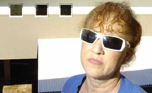 Blinded by the light: Resident Glenda Pierce of Killarney Crescent at Skennars Head, has to wear sunglasses due to the glare coming off her neighbour’s new roof. . Picture: Jerad Williams