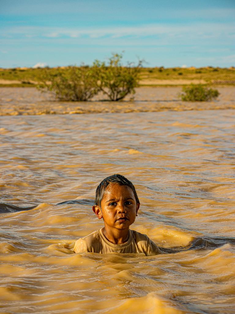 Flood waters from Tropical Cyclone Kirrily have reached Birdsville with those in the area having some fun in the water. Picture: Peta Rowlands Wangkangurru/Yarluyandi Traditional Owner of Birdsville