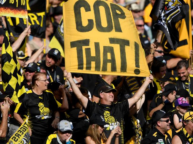 Tiger fans celebrate a goal during the Round 3 AFL match between the Richmond Tigers and the Hawthorn Hawks at the MCG in Melbourne, Sunday, April 8, 2018. (AAP Image/Joe Castro) NO ARCHIVING, EDITORIAL USE ONLY