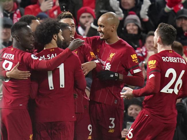 Liverpool players celebrate their first goal during the English Premier League soccer match between Liverpool and West Ham at Anfield Stadium in Liverpool, England, Monday, Feb. 24, 2020. (AP Photo/Jon Super)