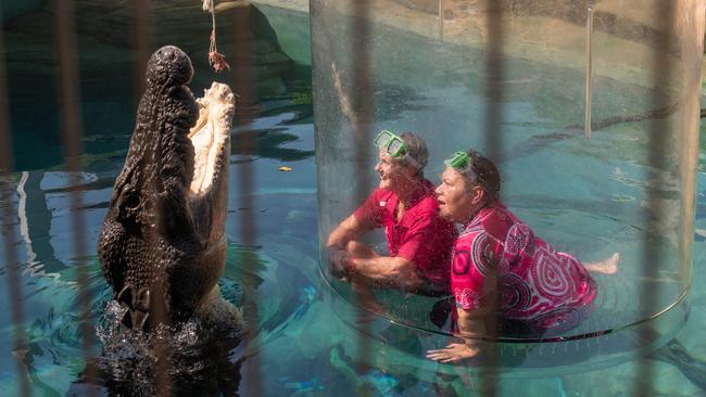 Breast cancer survivor Glenda Reid and BreastScreen NT representative Natalie Stokes entering the cage of death at the Crocosaurus Cove, Darwin. Picture: Pema Tamang Pakhrin