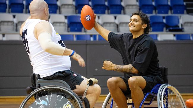 AFL star Jamarra Ugle-Hagan with wheelchair AFL players Joanna Argaet and Chris Henderson ahead of the Wheelchair AFL National Championships. Picture: Mark Stewart