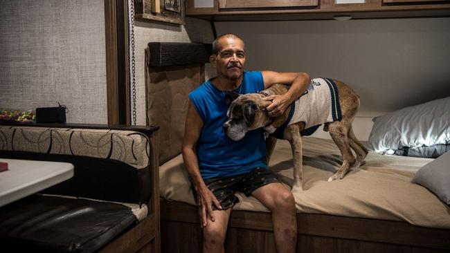 Abe Guerrero and his dog, Toby, inside the trailer he shares with a friend in an RV park on the outskirts of Odessa. Picture: Cengiz Yar