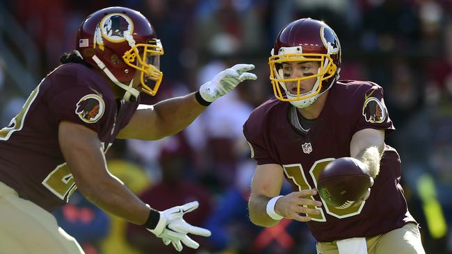 Colt McCoy hands off to Roy Helu.