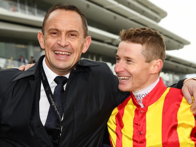 Trainer Chris Waller poses with jockey James McDonald after he rode Nature Strip to victory in race 5, the Darley Sprint Classic, during Seppelt Wines Stakes Day at Flemington Racecourse in Melbourne, Saturday, November 9, 2019. (AAP Image/Vince Caligiuri) NO ARCHIVING, EDITORIAL USE ONLY