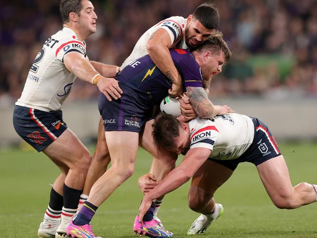 Cameron Munster is crunched by three Roosters. Picture: Kelly Defina/Getty Images