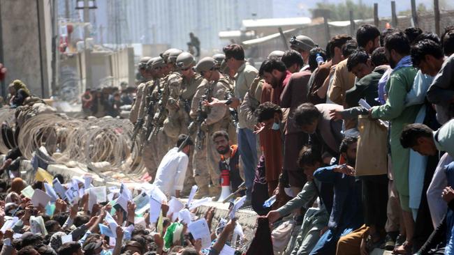 Afghans struggle to reach the foreign forces to flee the country outside the Hamid Karzai International Airport, in Kabul. Picture: EPA.