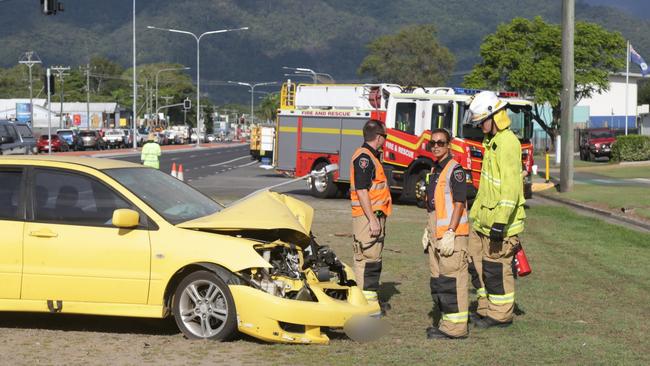 An early model Mitsubishi Lancer crashed into a light pole on Anderson St and was towed from the scene by Barron River Towing. Picture: Peter Carruthers