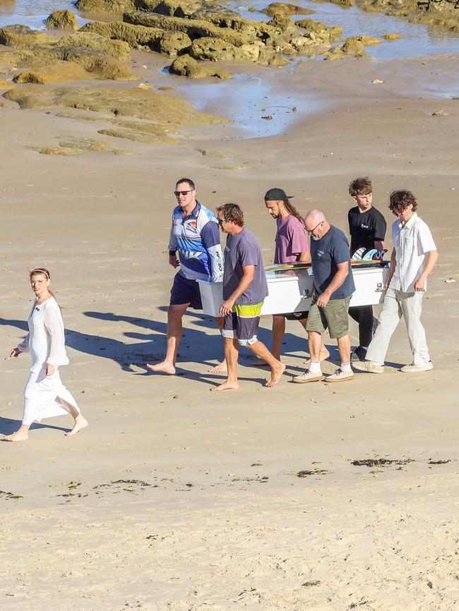 The pallbearers carry Khai Cowley’s coffin on to the beach. Picture: Russell Millard Photography