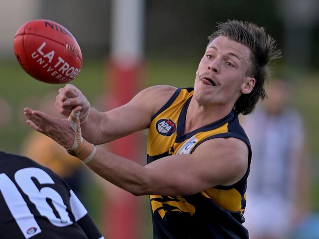 Blake Watson shooting out a handball for Whittlesea. Picture: Andy Brownbill