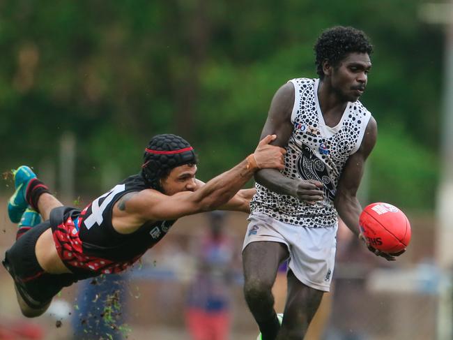 Hawks legend Cyril Rioli attempts a tackle at full stretch against Palmerston on Bathurst Island during the 2019-20 season. Picture: Glenn Campbell