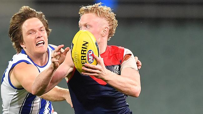 Adelaide, AUSTRALIA – AUGUST 09: Clayton Oliver of the Demons gets away from Jared Polec of the Kangaroos during the round 11 AFL match between the Melbourne Demons and the North Melbourne Kangaroos at Adelaide Oval on August 09, 2020 in Adelaide, Australia. (Photo by Mark Brake/Getty Images)