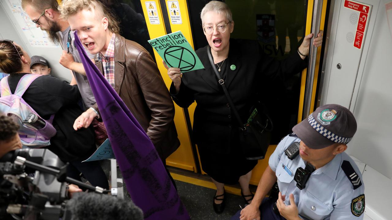 Extinction Rebellion protesters swarm Sydney trains as part of a disruption tactic. Picture: Damian Shaw