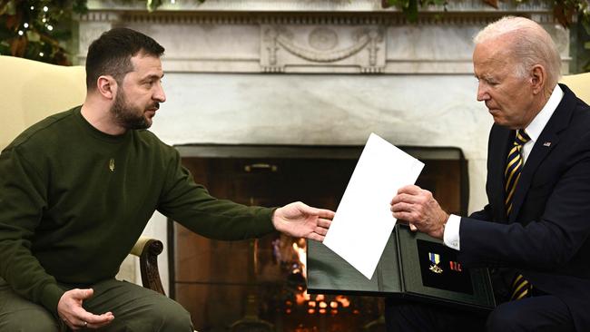 US President Joe Biden with the award for military merit, presented to him by Volodymyr Zelenskyy after a captain named Pavlo passed it on to him. Picture: AFP