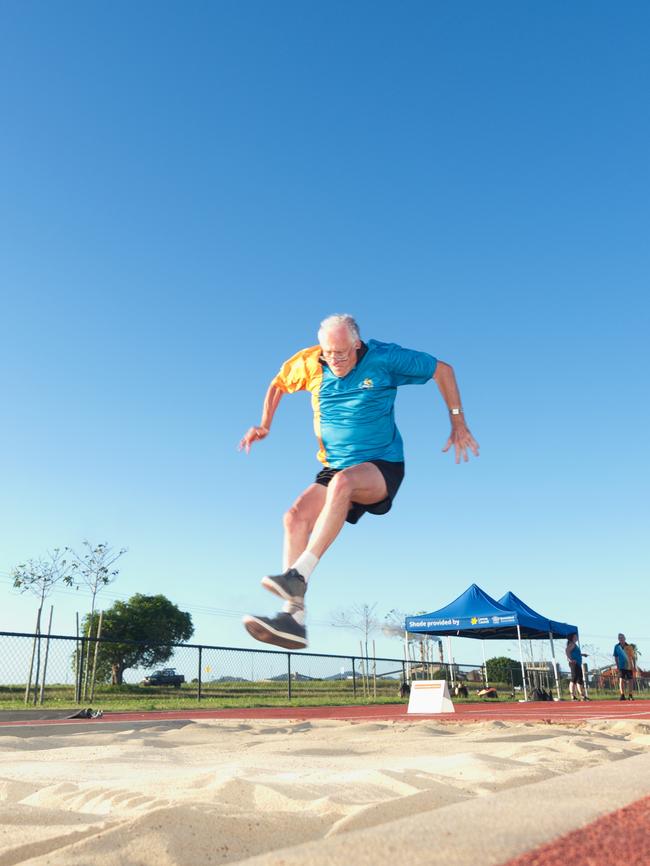 Terry Ryan treads the board and gets some height is his long jump. Mackay Athletics Summer Series. November 20th, 2021. Picture: Marty Strecker